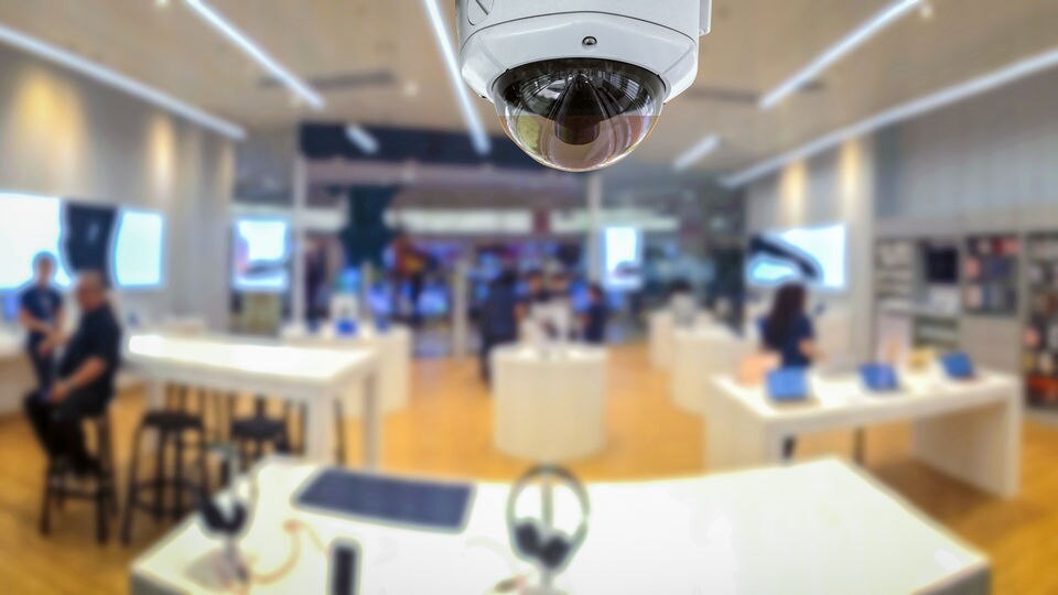 overhead digital surveillance camera with view of retail electronics store in background