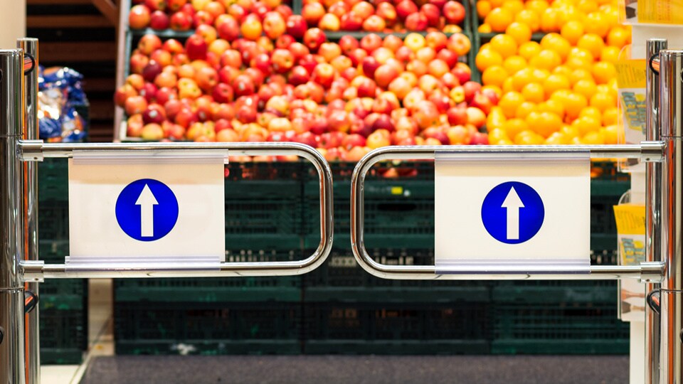 push gates entering produce department of retail grocery store