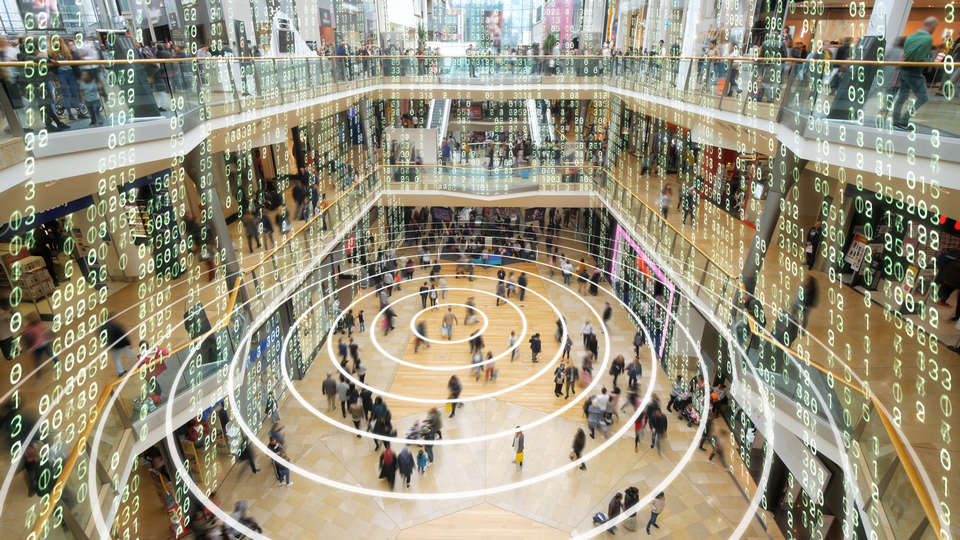 crowded multi-level retail shopping mall with conceptual overlay of data