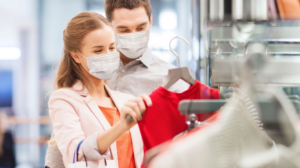 couple wearing masks shopping in retail store