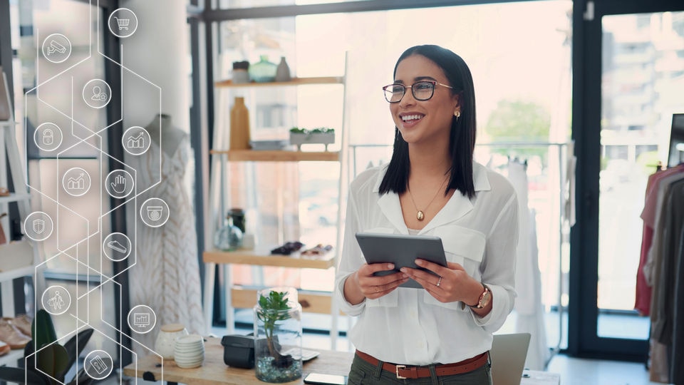 female retail store associate holding device next to sensormatic iq icon overlay