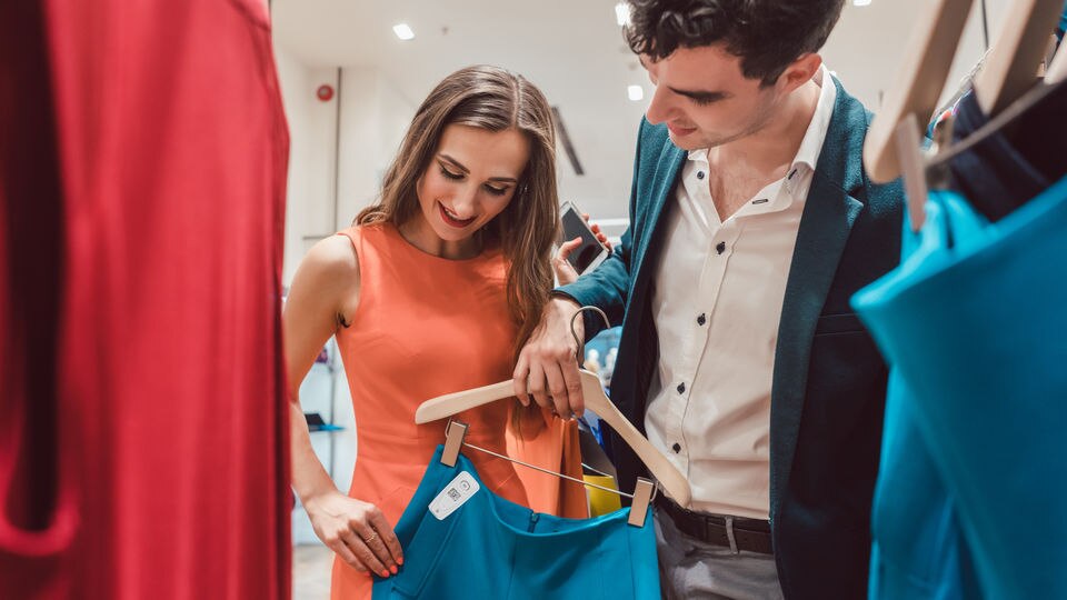 man & woman looking at skirt tagged with sensormatic infuzion hard tag
