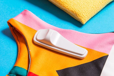 sensormatic hard tag attached to colorful piece of retail apparel