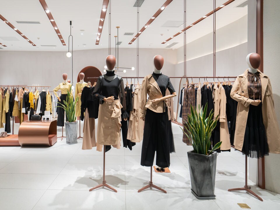 Mannequins displaying womens clothing in bright store