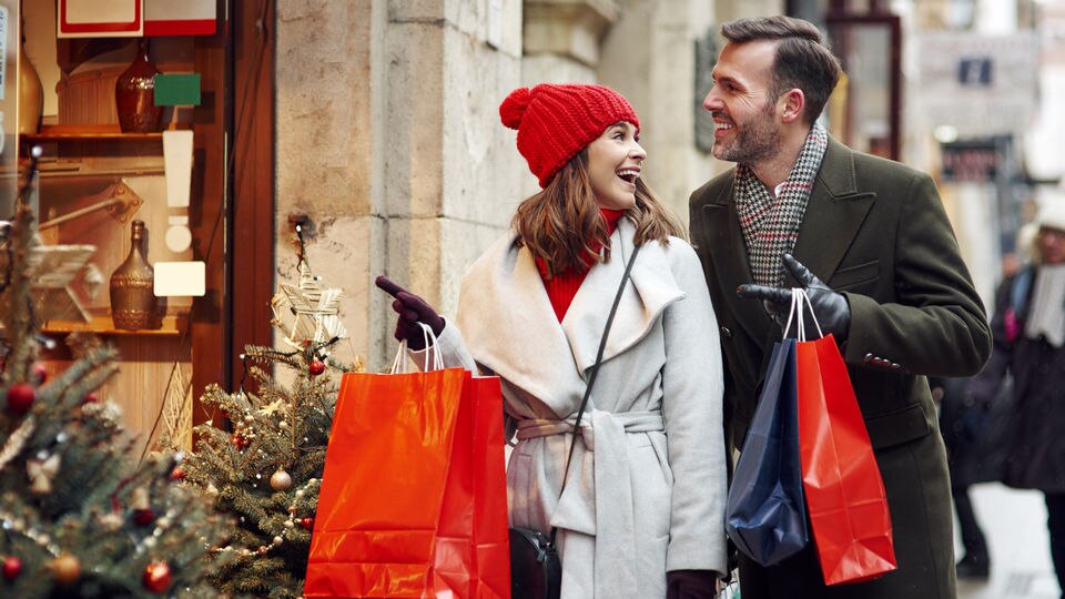 male female couple shopping in retail area during holiday season