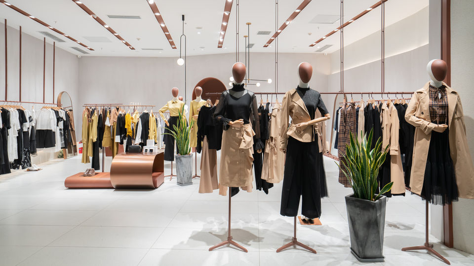 interior of bright modern retail apparel store with several mannequins