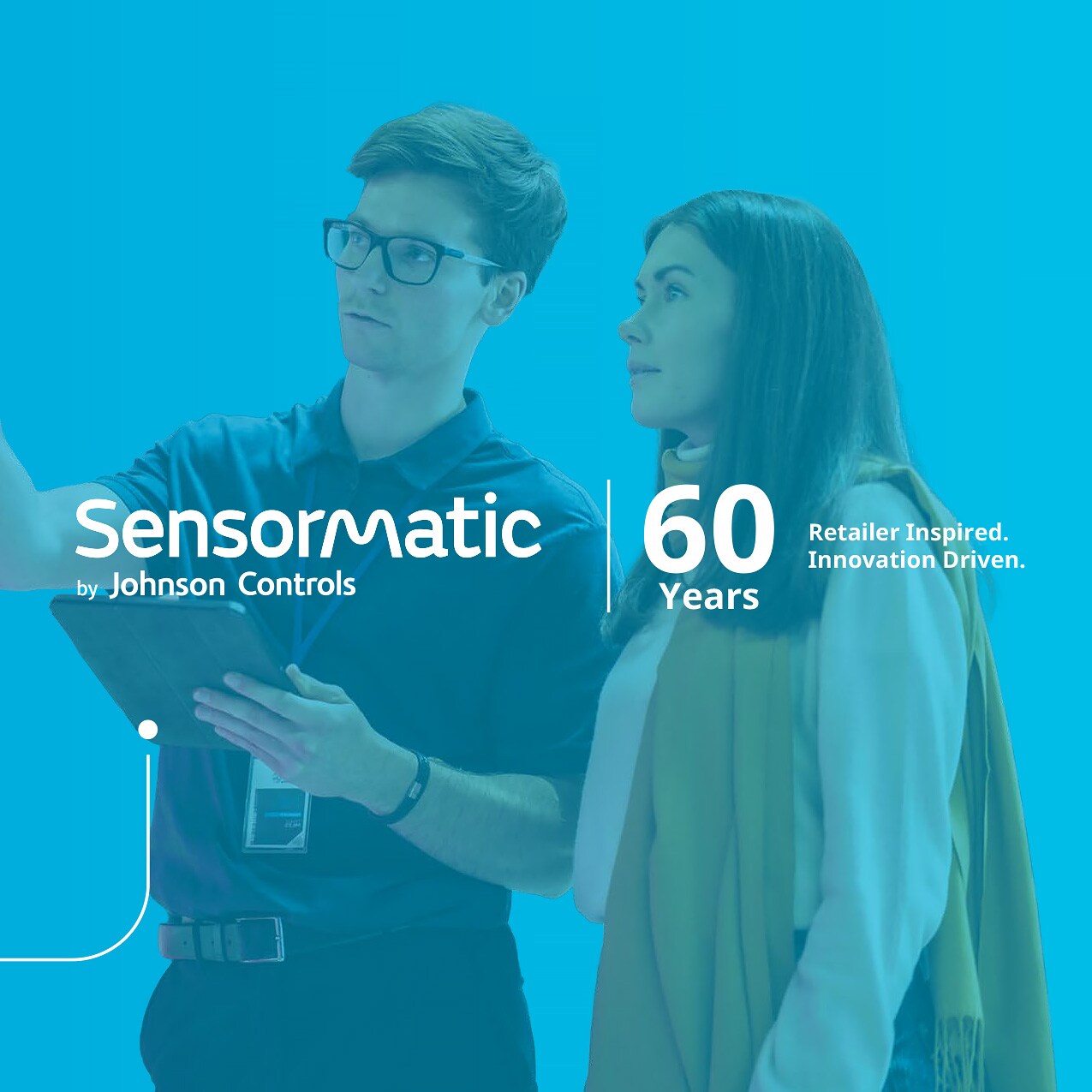 sensormatic 60th anniversary redefining retail carousel slide 6: male retail store employee pointing out features of merchandise to a female shopper using an electronic tablet device. with with sensormatic logo and 60th anniversary tagline: retailer inspired. innovation driven.