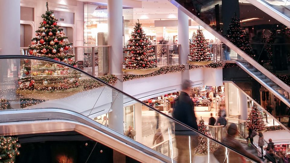 busy retail shopping mall decorated for year-end holiday season