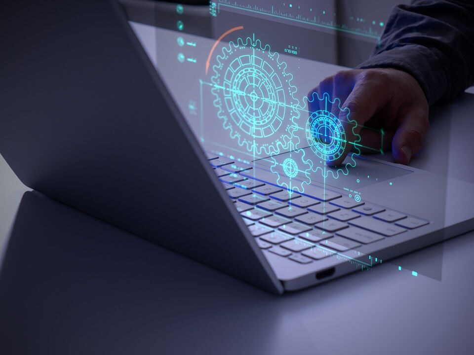 retail manager working on a laptop reviewing store performance with data superimposed over image