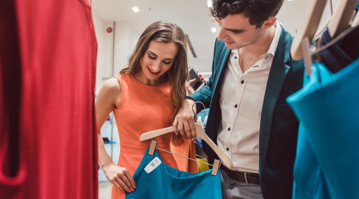 male and female shopper looking at rfid tagged apparel