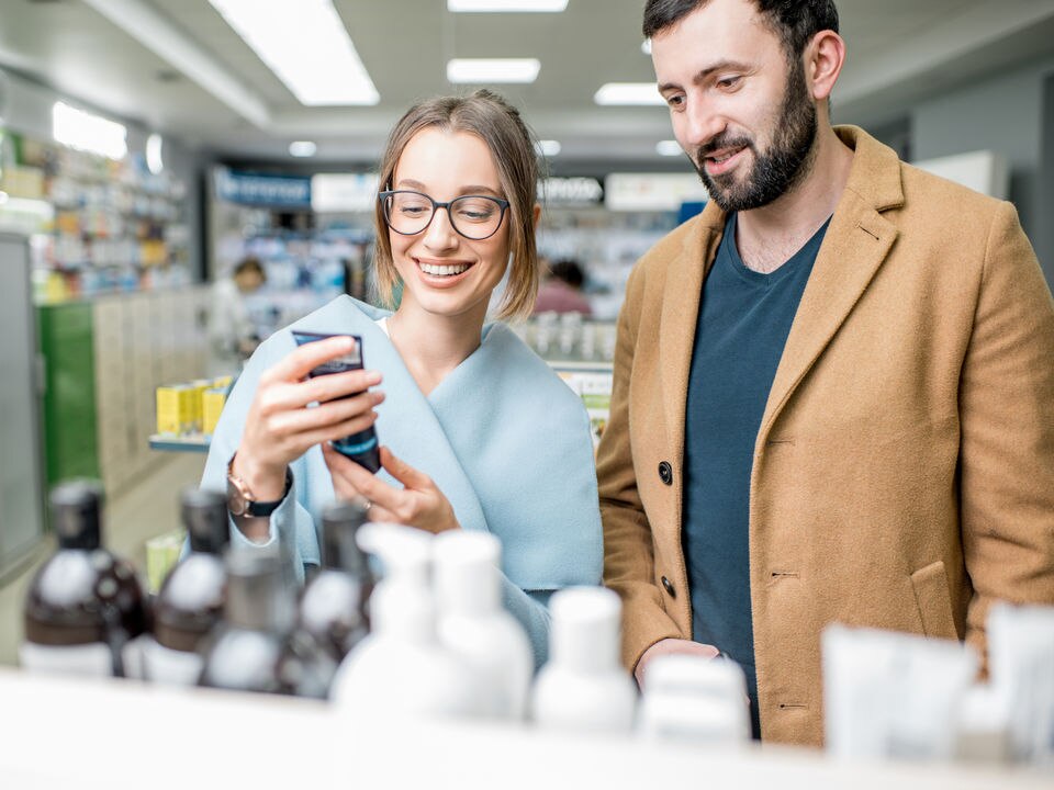 male and female couple shopping for health and beauty products at retail store