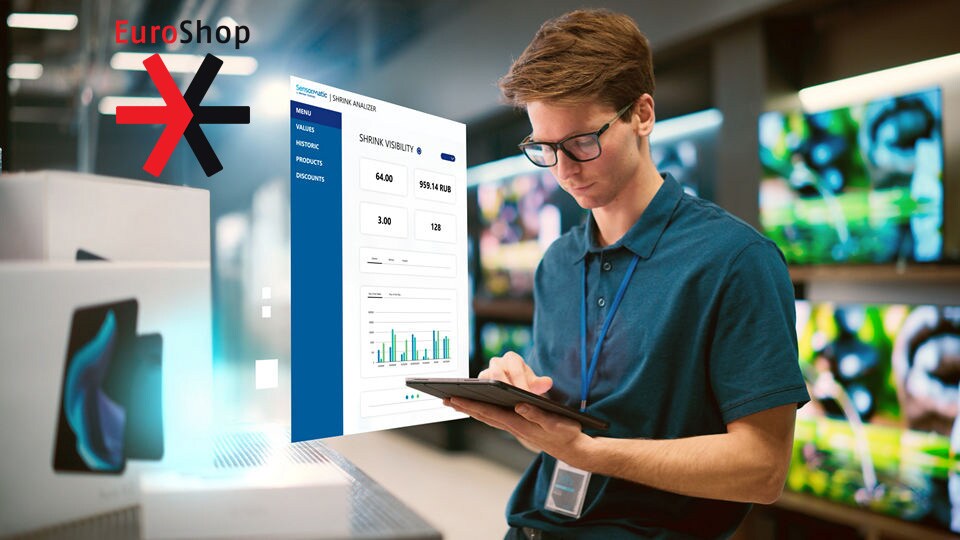 sales associate in retail electronics store reviewing data on his tablet displaying sensormatic shrink analyzer application with euroshop 2026 logo superimposed