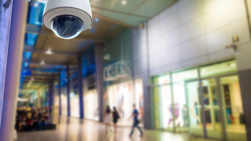 overhead video surveillance camera in retail shopping mall