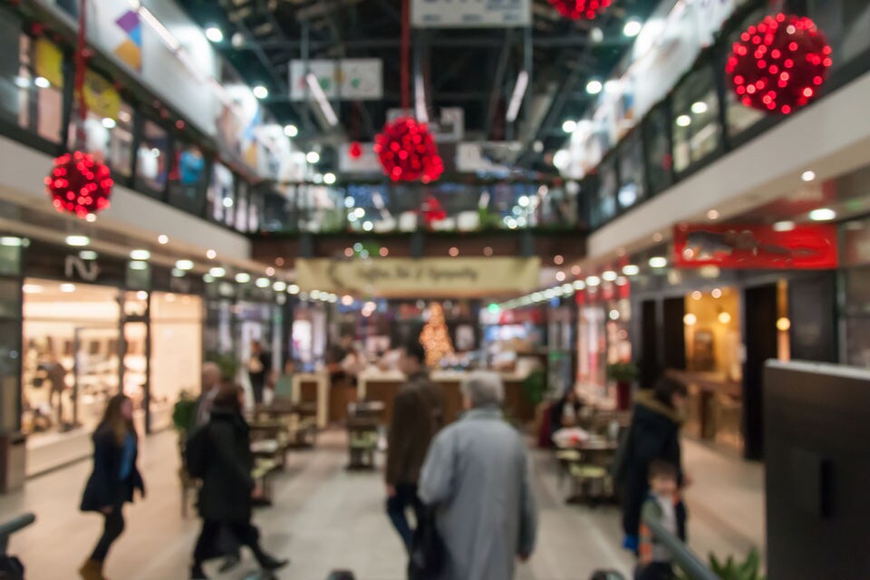 shoppers in mall with christmas decorations