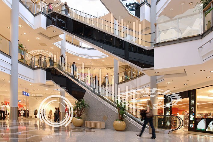 conceptual image of multi-level mall overlaid with numbers and graphs