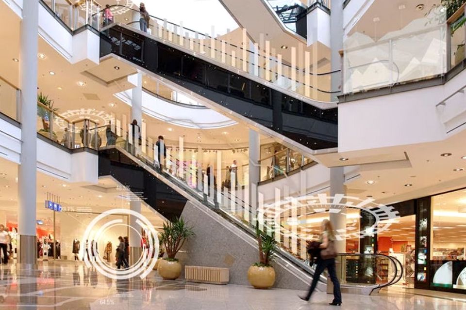 interior of multi-level retail shopping mall with futuristic data overlays