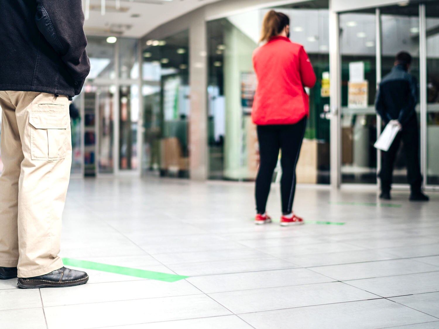 customers practicing social distancing at store entrance