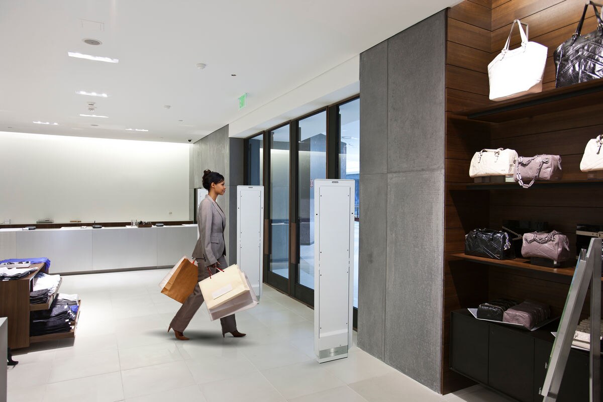 Woman exiting store through detection pedestals