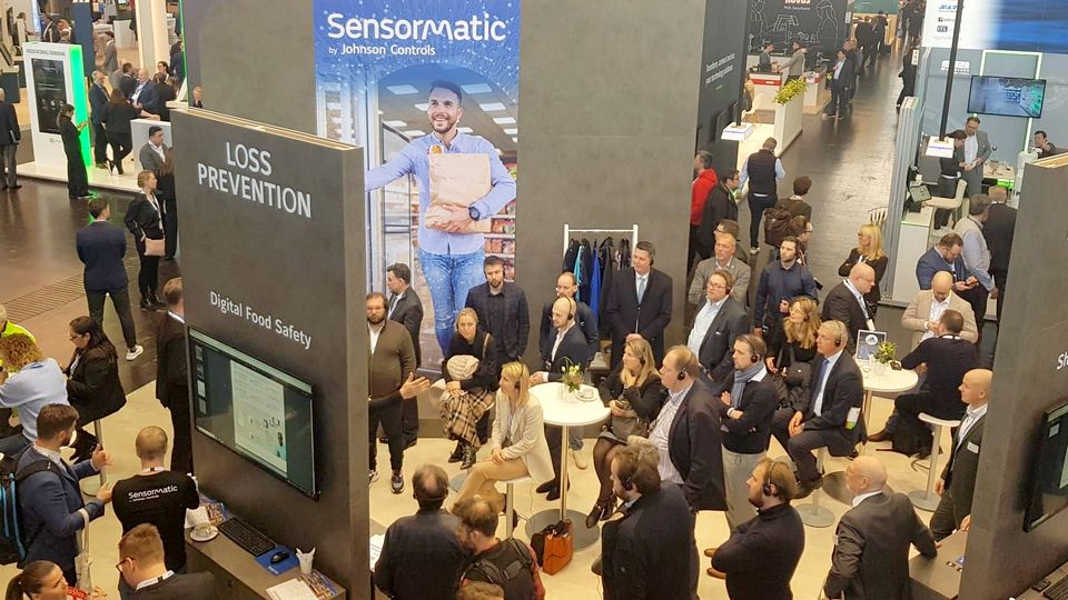 overhead view of busy sensormatic booth at euroshop 2023 retail trade fair in düsseldorf