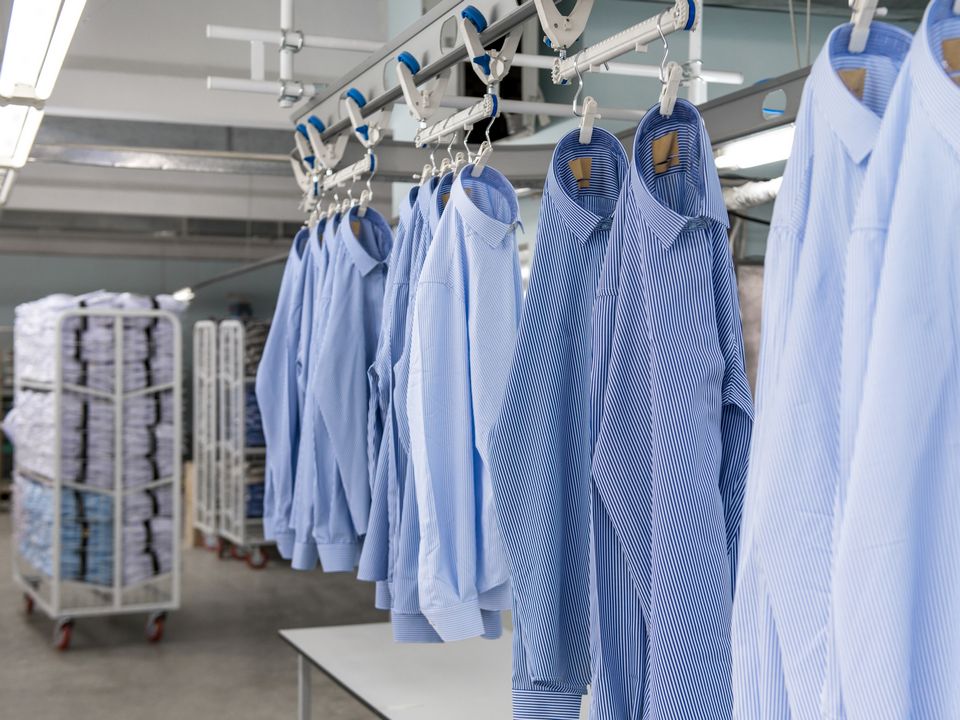 blue shirts in factory having rfid tags applied for inventory in retail stores