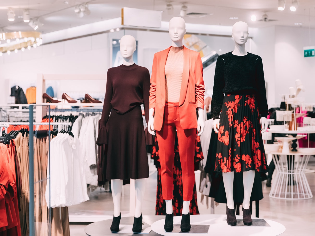 Mannequins displaying womens clothing in bright store