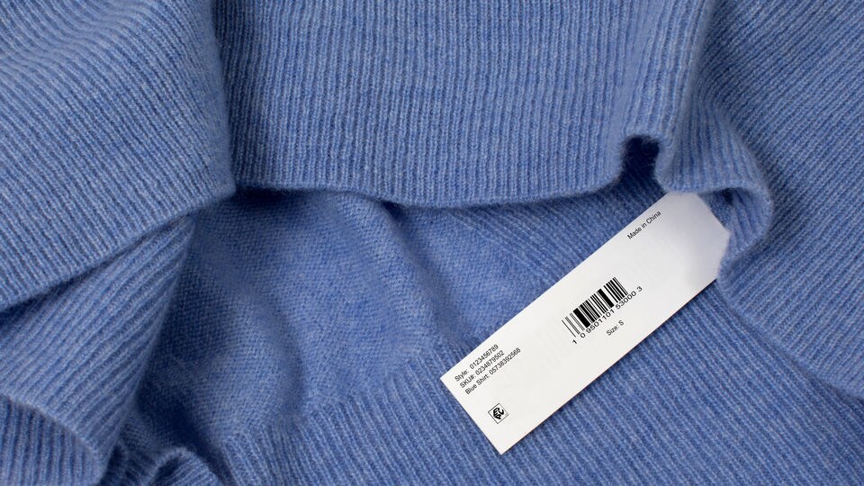 rfid epc label sewn into blue sweater at the factory