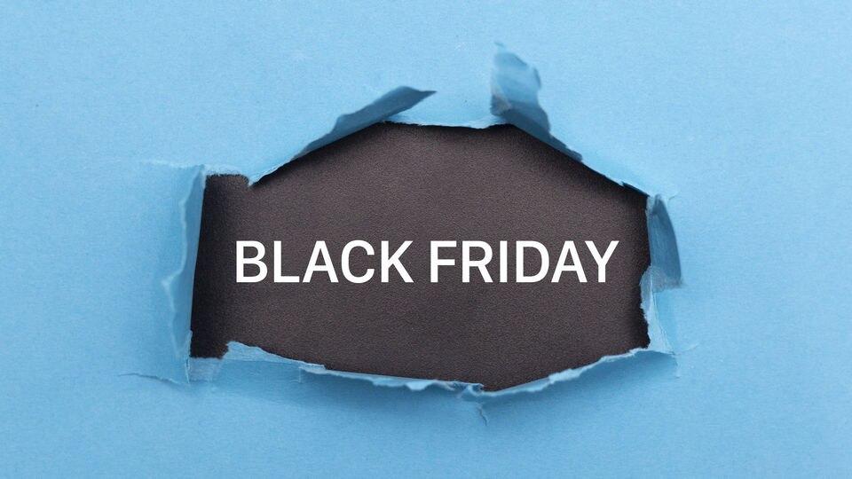 light blue paper background with black friday text bursting through