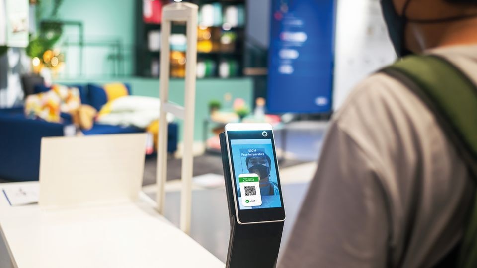 retail store employee has face scanned via device