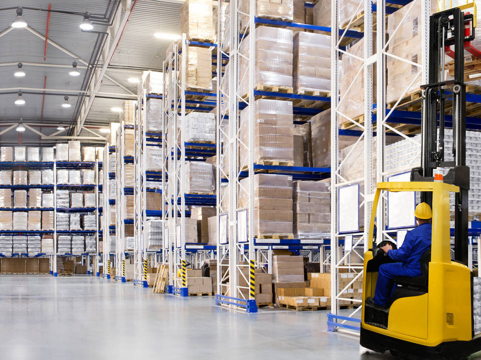 interior of retail warehouse with forklift and operator