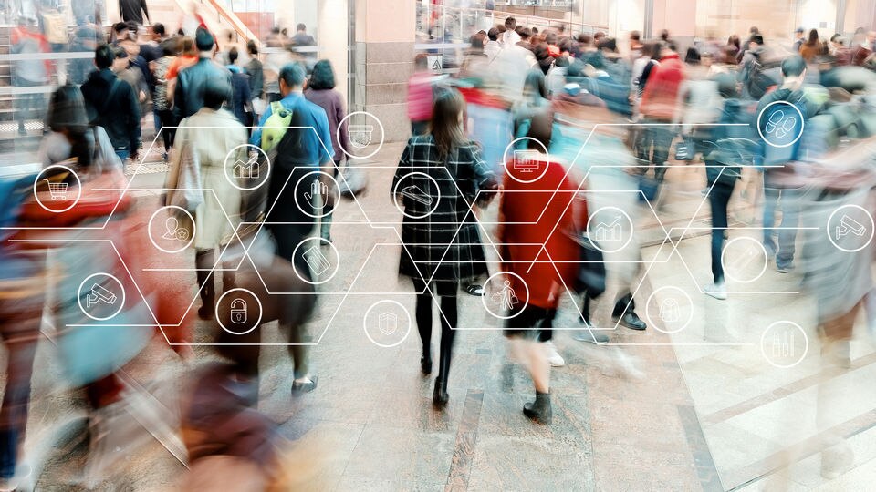 many people on busy retail shopping street with sensormatic iq logos overlaid