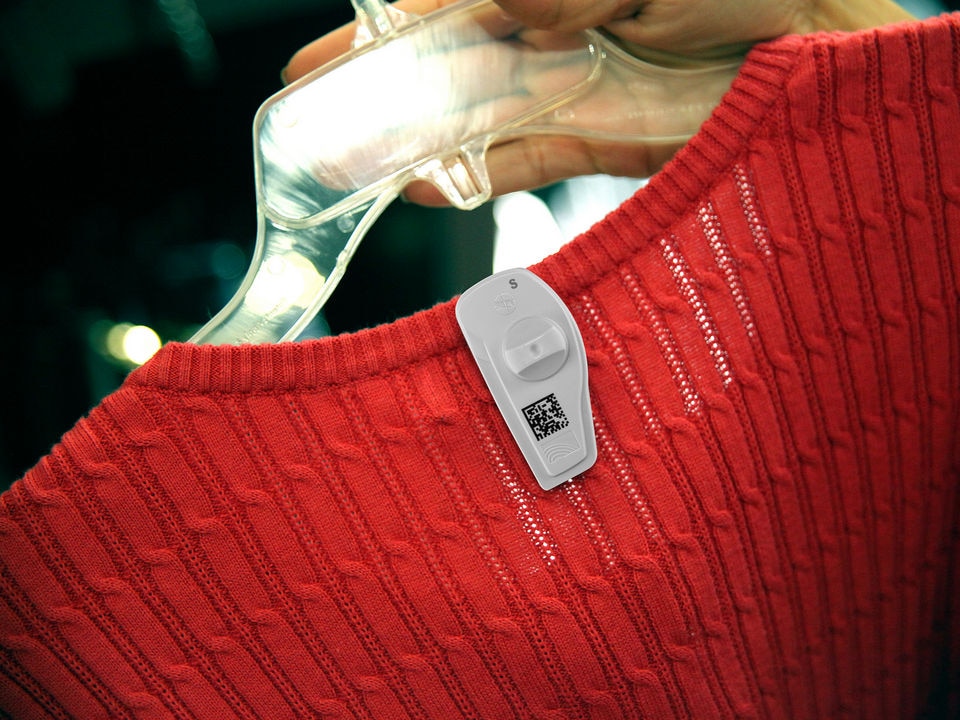 knit womens garment in retail store on hanger with rfid barcode hard tag