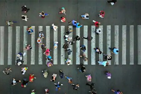 overhead shot of people crossing city street